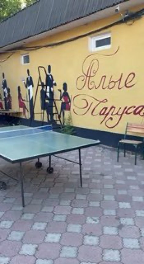 Стол для настольного тенниса у стены с надписью «Алые паруса»